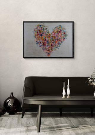 Herzblick by ullimcart in a black frame on a pale wall above a dark sofa with candlesticks