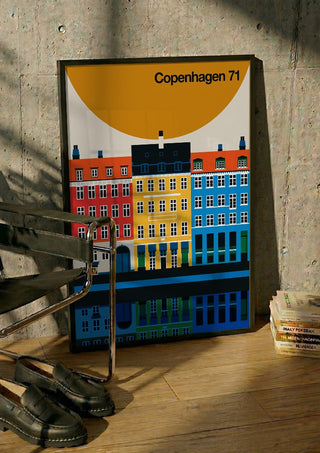Copenhagen 71 by Bo Lundberg in a black frame leaning against a concrete wall by a steel chair