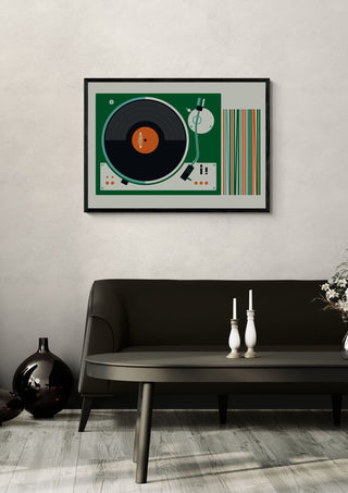 Record Player by Bo Lundberg in a black frame on a pale wall above a dark sofa with candlesticks