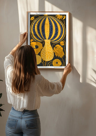Yellow Dotted Pumpkin by Yokohama being hung on a sunlit wall