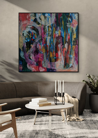 All Roads Lead Home by Janet Bell in a black frame on a grey wall above a dark sofa with candlesticks