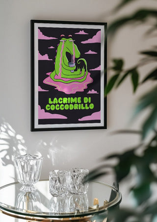 Crocodile Tears by Elisa Albanelli in a black frame above a glass table with crystal glassware