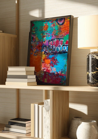 art against the maschine by hazelart in a dark frame on a wooden shelf beside books and a lamp