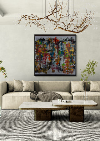 Schmetterling by ullimcart in a black frame above a pale sofa under a branch chandelier