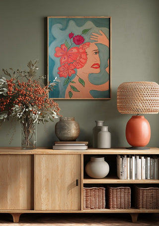 Flowers in head by Carmen Coduri above a wooden sideboard on a sage green wall
