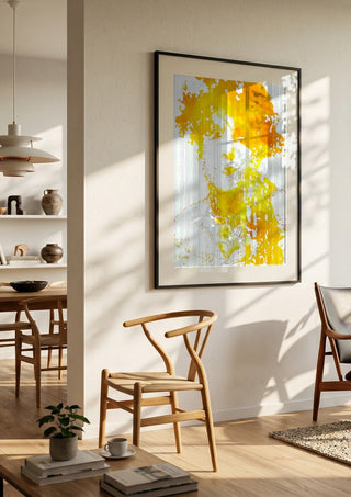 Sunshine by Bent Hardervig in a black frame in a bright dining room with wooden chairs
