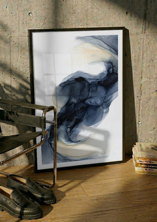 Frozen Light by Anna Dormir in a black frame leaning against a concrete wall by a steel chair