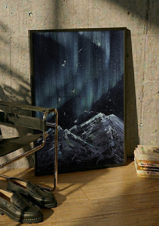 Aurora by Zhan Snow in a black frame leaning against a concrete wall by a steel chair