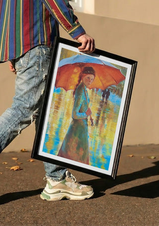 Woman with an Orange Umbrella by Mariia Nikolina carried in a black frame along a sunny street