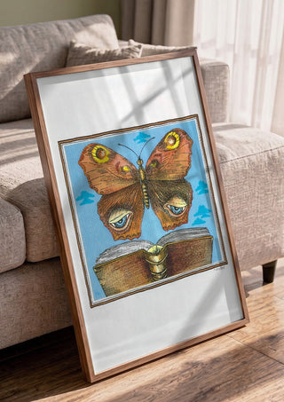 The Butterfly and the Book by Waldemar Mandzel in a walnut frame leaning against a grey sofa