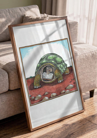 The Reading Tortoise by Waldemar Mandzel in a walnut frame leaning against a grey sofa