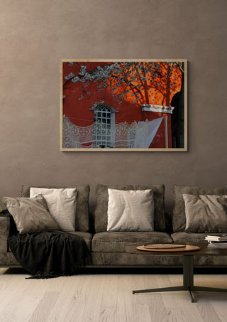Lace and Blossom, Christiania by Helene Høie in a pale wooden frame above a grey sofa with cushions