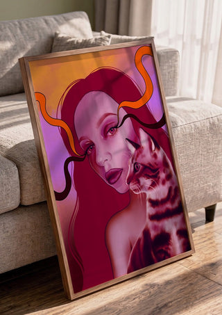 Glow And Purr by Sabrina Rosenblatt in a walnut frame leaning against a grey sofa