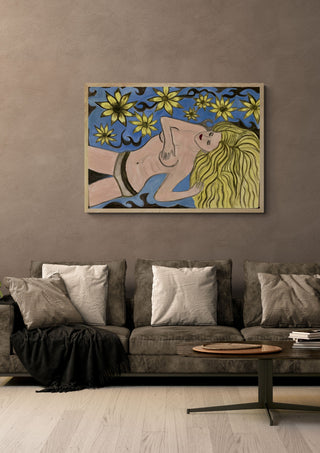 Die Blonde by Carmen Coduri in a pale wooden frame above a grey sofa with cushions