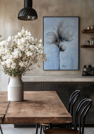 Cotton by Marina Agre in a black frame above a rustic table with white flowers