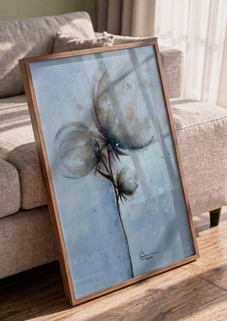 Cotton by Marina Agre in a walnut frame leaning against a grey sofa