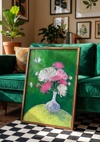 Chrysanthemums by Deblina Dey in a wooden frame beside a green velvet sofa on a chequered floor