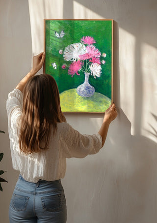 Chrysanthemums by Deblina Dey being hung on a sunlit wall