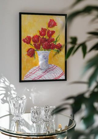 Tulips - II by Deblina Dey in a black frame above a glass table with crystal glassware