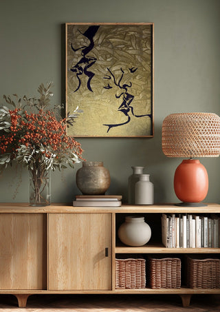 Whispers in Gold by Bibi above a wooden sideboard on a sage green wall