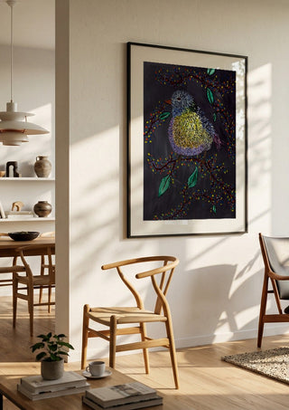 Digital Alchemy by Bibi in a black frame in a bright dining room with wooden chairs