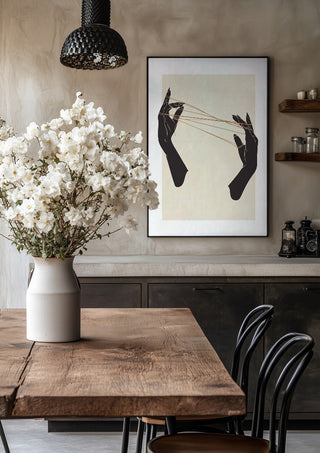 Unclear plans by Nari in a black frame above a rustic table with white flowers