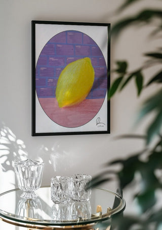 ABCitron by L.OE. Art in a black frame above a glass table with crystal glassware