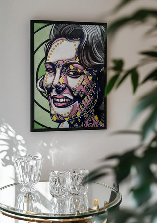 Vertigo by Okiana in a black frame above a glass table with crystal glassware