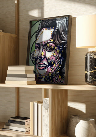 Vertigo by Okiana in a dark frame on a wooden shelf beside books and a lamp