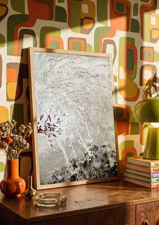 Pain by Tonia in a wooden frame on a sideboard against retro patterned wallpaper