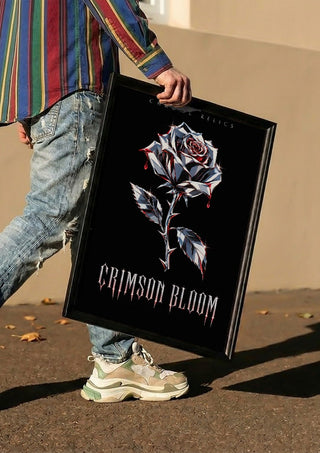 Crimson Bloom by Melancholy Machinations carried in a black frame along a sunny street