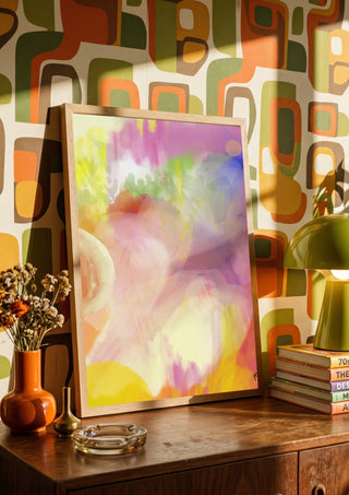 Color rond by FridaRit in a wooden frame on a sideboard against retro patterned wallpaper