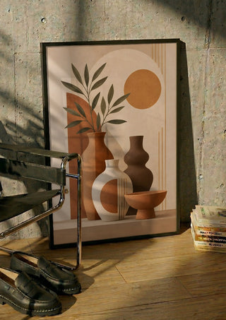 Earth Tone Still Life with Ceramic Vases by TimlessArtworks in a black frame leaning against a concrete wall by a steel chair