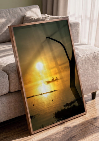 Fishermen Of Naivasha by Gloria Mwivanda in a walnut frame leaning against a grey sofa