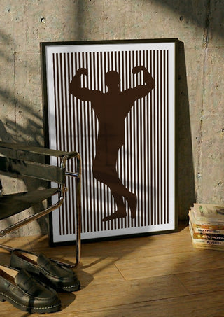 bodybuilder silhouette by nyai in a black frame leaning against a concrete wall by a steel chair