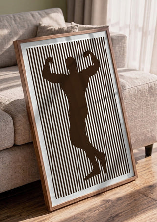 bodybuilder silhouette by nyai in a walnut frame leaning against a grey sofa