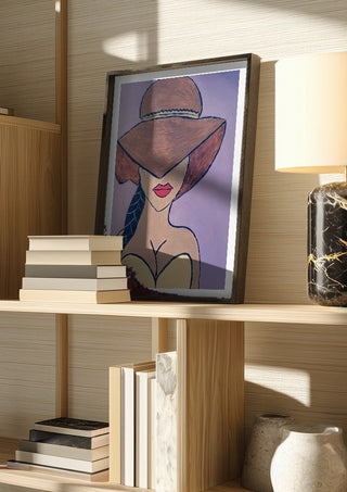 Shaded Allure by Bibi in a dark frame on a wooden shelf beside books and a lamp