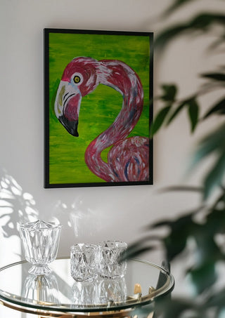 Vibrant Flamingo by Bibi in a black frame above a glass table with crystal glassware