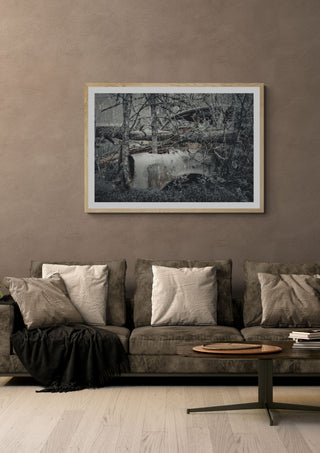 Decay by Lone Gjessing in an oak frame above a grey sofa with cushions