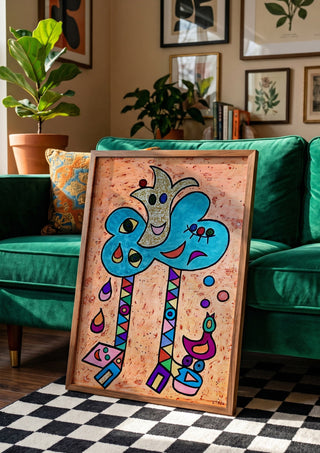 Blue Tree with Faces by Steffi Seiler in a wooden frame beside a green velvet sofa on a chequered floor