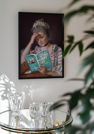 Make a Tik Tok by Dikhotomy in a black frame above a glass table with crystal glassware