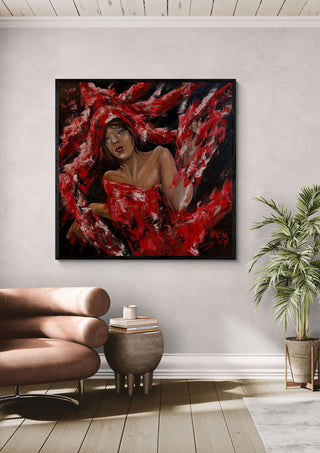The Party by Ronny Simon in a black frame above a pink armchair beside a palm