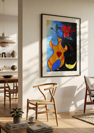 Human Vase by A Sleepy Spirit Art in a black frame in a bright dining room with wooden chairs
