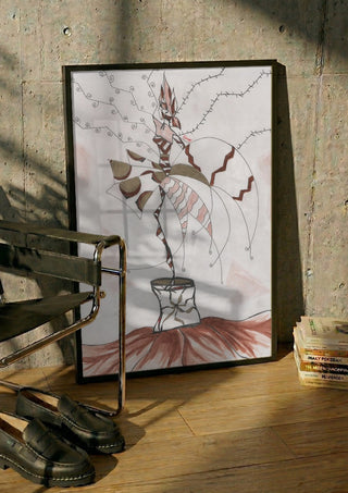Earth Fairy by A Sleepy Spirit Art in a black frame leaning against a concrete wall by a steel chair