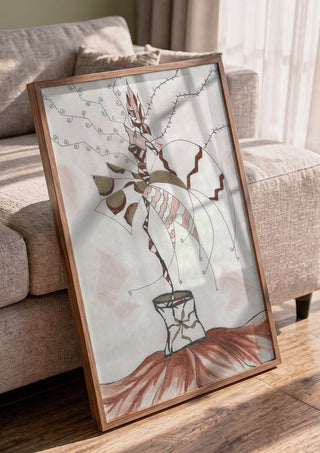 Earth Fairy by A Sleepy Spirit Art in a walnut frame leaning against a grey sofa