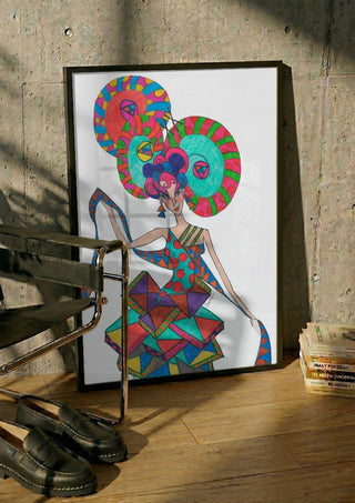 Life is geometry by A Sleepy Spirit Art in a black frame leaning against a concrete wall by a steel chair
