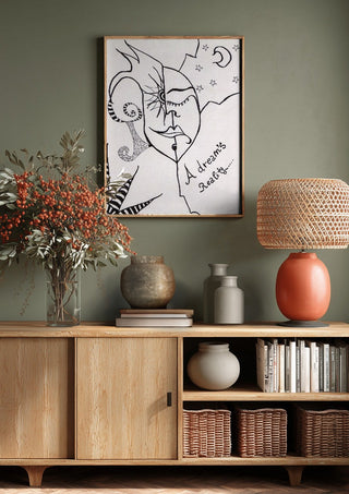 A dreams' reality by A Sleepy Spirit Art above a wooden sideboard on a sage green wall