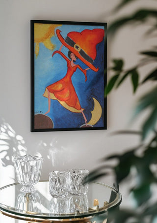 Balance Exercise by A Sleepy Spirit Art in a black frame above a glass table with crystal glassware