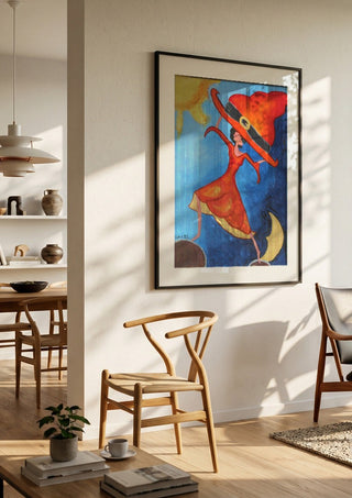 Balance Exercise by A Sleepy Spirit Art in a black frame in a bright dining room with wooden chairs