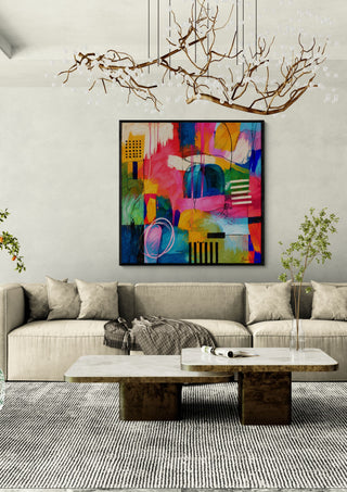 Jazz Puls II by Bondero in a black frame above a beige sofa under a branch chandelier